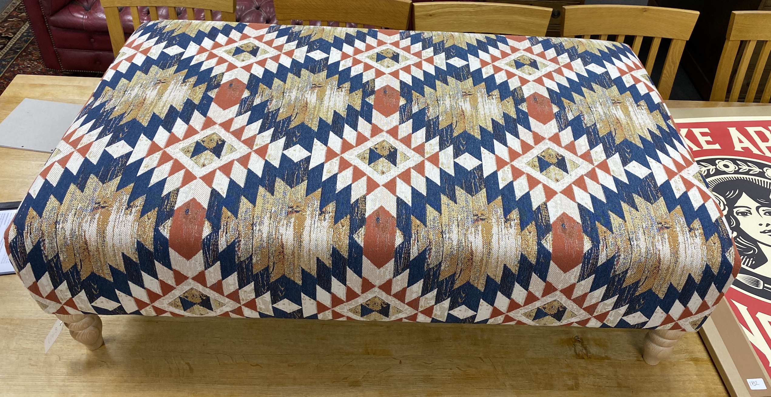 A large contemporary rectangular footstool upholstered in Kilim style polychrome fabric on turned beech feet, length 124cm, depth 75cm, height 38cm